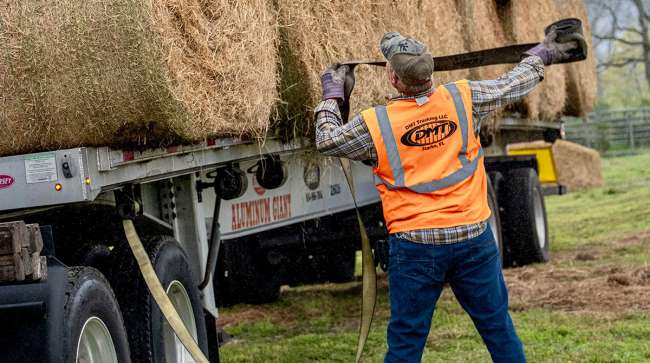 Alabama trucking volunteers load hay