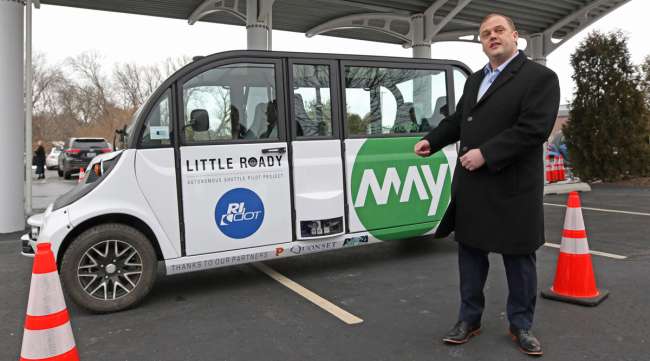 Edwin Olson, CEO of May Mobility, stands with one of the Little Roady autonomous vehicles at the project announcement in Providence in February 2019.