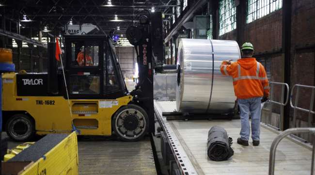 Workers load an aluminum coil onto a loading dock in a Tennessee manufacturing facility in January 2017.
