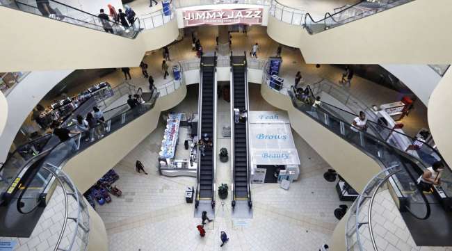 Shoppers walk through the Queens Center shopping mall in Queens, N.Y., on Sept. 9.