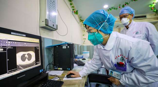 Doctors look at a CT scan of a patient at a hospital in Wuhan in central China's Hubei Province on Jan. 30.
