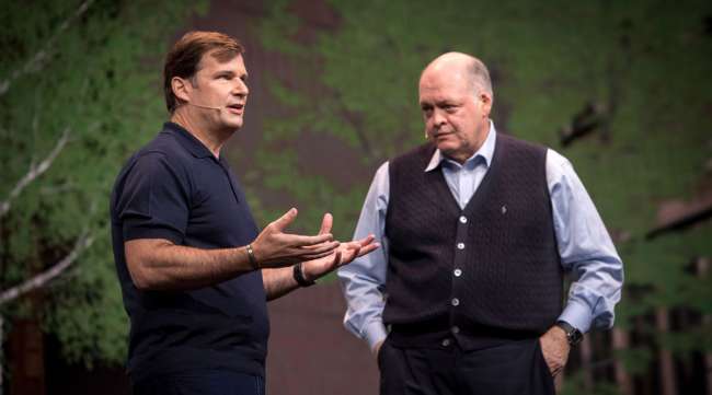 James Farley speaks as Jim Hackett listens during an event at CES in Las Vegas in 2018.