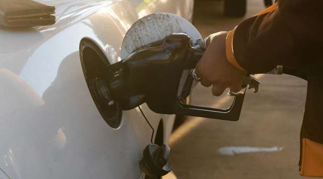 A driver refuels their vehicle at a Shell gas station in La Jolla, Calif.