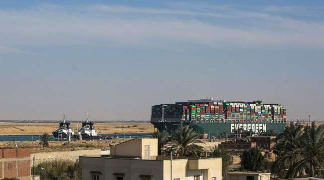 Tug boats pull the Ever Given containership along the Suez Canal on March 29.