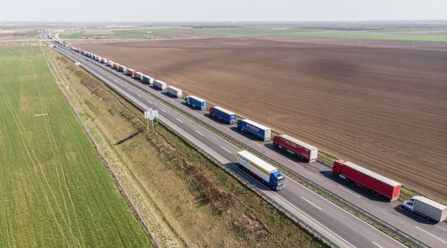 Trucks stand in a queue while waiting to cross the border from Hungary into Romania on April 8.