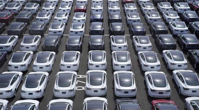 Tesla vehicles sit in a lot after arriving at a port in Japan. (Toru Hanai/Bloomberg News)