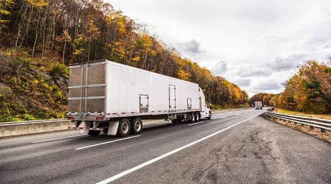 Trucks on the road in autumn