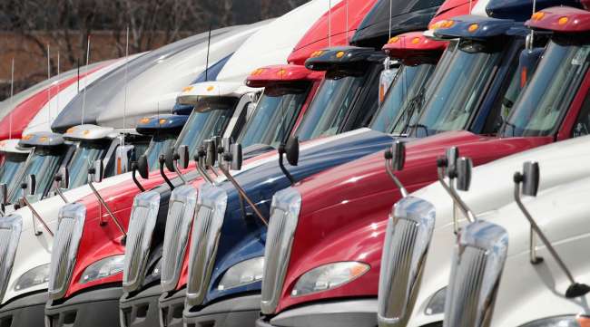 International trucks sit parked in a lot outside a Navistar facility.