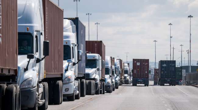 Trucks wait in line to enter the Port of Oakland in March 2020. (David Paul Morris/Bloomberg News)