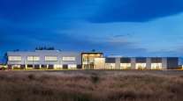 Aurora Montana facility with lights on