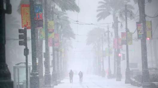 Snow falls on Canal Street in New Orleans