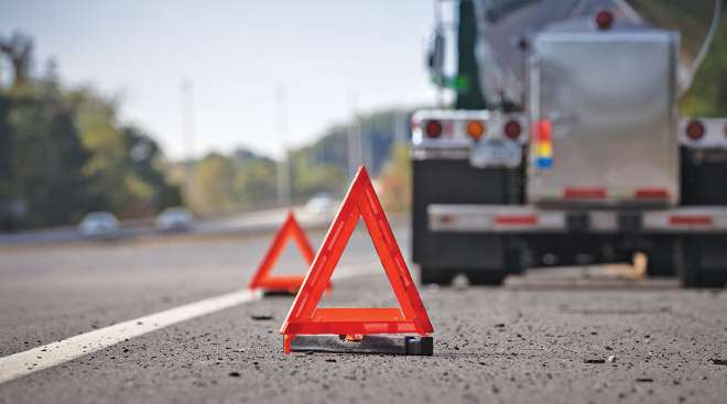 Truck parked with warning triangles behind it