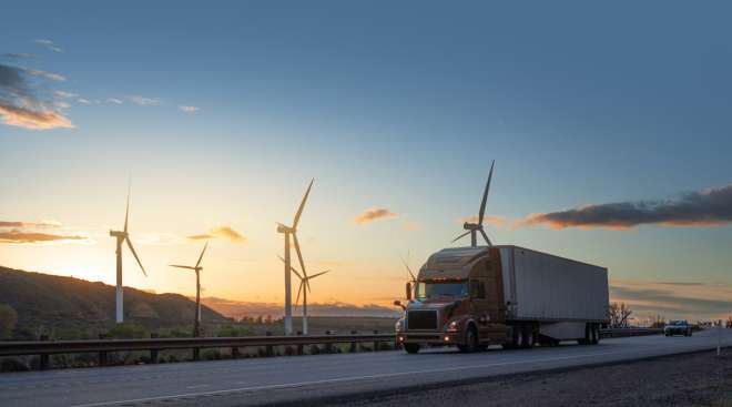 Truck in front of wind turbines