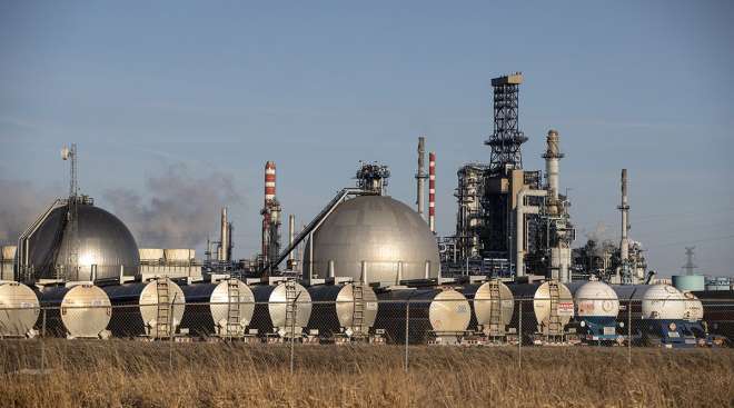 Storage tanks and trucks at oil refinery in Canada